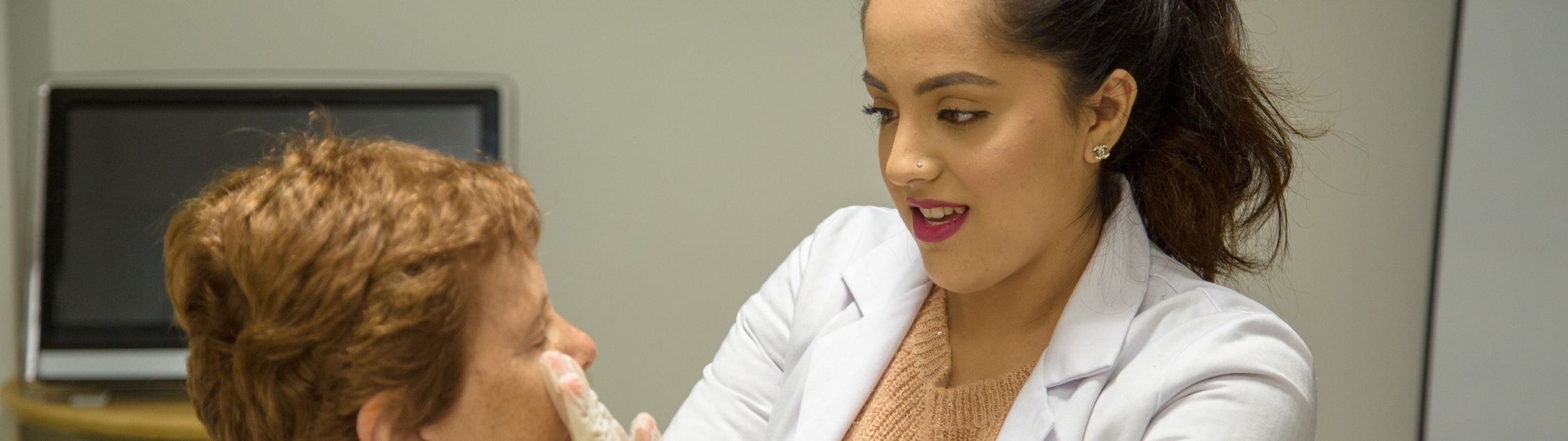 Intern in white coat gives a nutrition exam